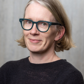 Shona wearing glasses looking at camera