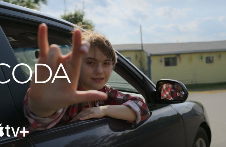 A woman uses sign language. Text reads: CODA, with the Apple TV + logo
