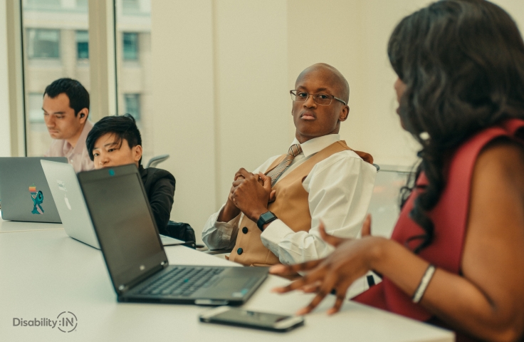 People are sitting at a meeting table