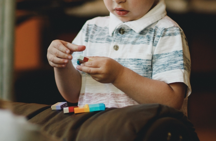 Young boy playing with lego