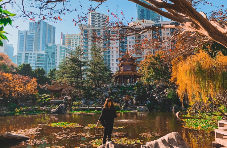 Women in black standing in the Chinese Gardens of Friendship in Sydney